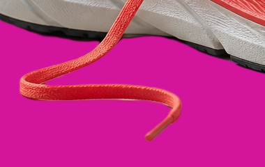 Loose shoe lace and the edge of the sole after background removal, on magenta, at 100%